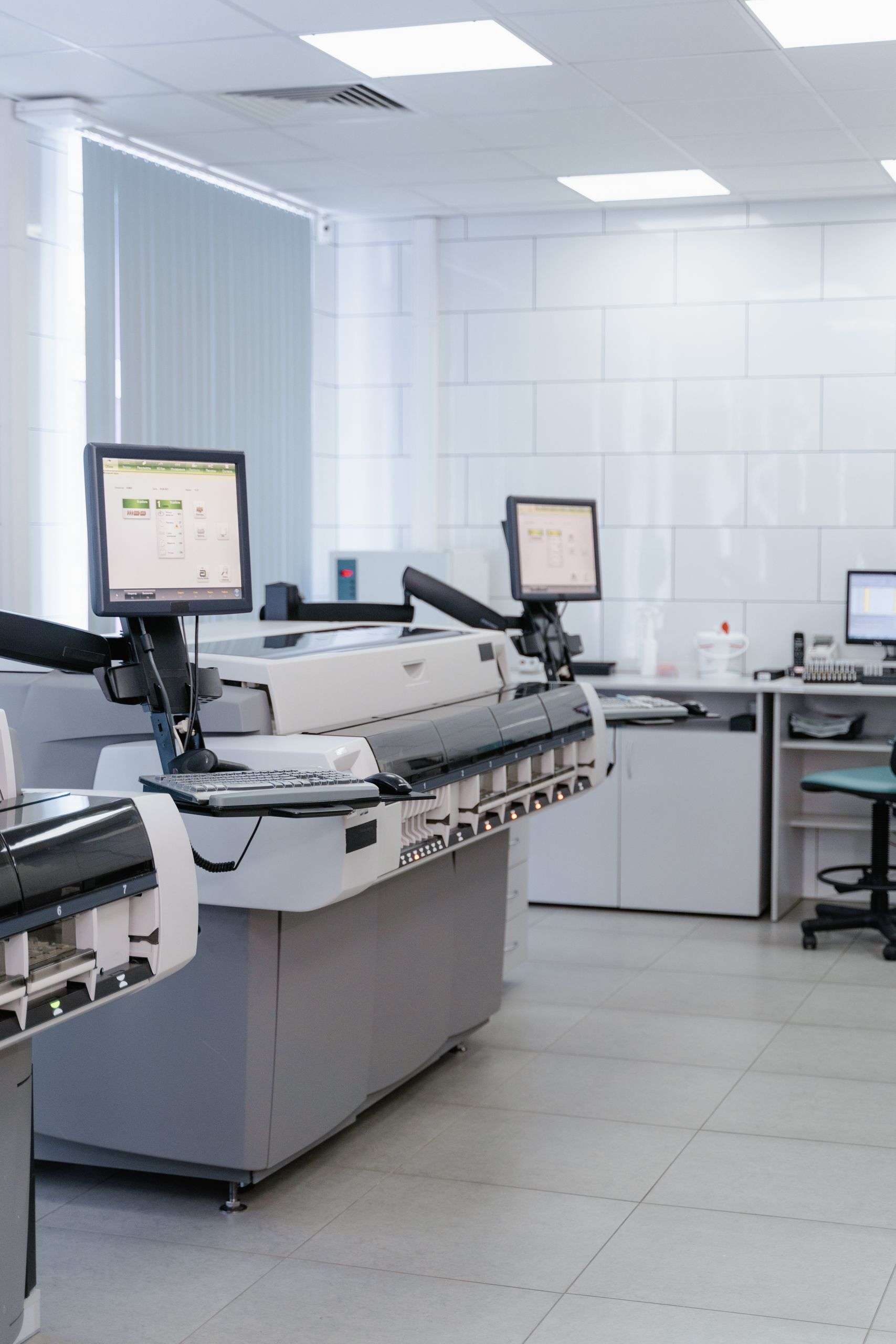 Bright and organized laboratory featuring high-tech printers and workstations.